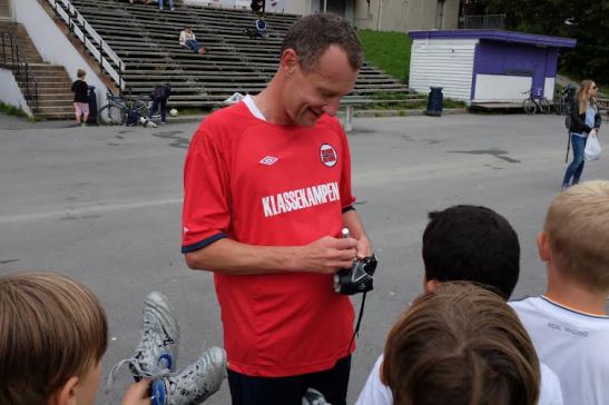 Nikolaj Frobenius skriver autografer.